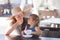 Mother and daughter eating ice cream at the restaurant.