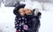 Mother and daughter enjoying snow in winter