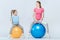 Mother and daughter exercising with fitness balls