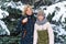 Mother and daughter family portrait in a winter forest, one parent and one children, beautiful nature with bright snowy fir trees