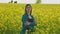 mother and daughter farming family in the rapeseed field pointing away