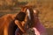 Mother and daughter feeding her handsome horse