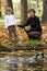 Mother and daughter feeds duck over pond