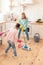 Mother and daughter feeling cheerful cleaning flat together