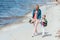 mother and daughter with floral bouquets holding hands