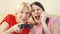 Mother and daughter gamers playing video game at home.Players with remote controller of game console