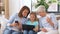 Mother, daughter and grandmother with gadgets