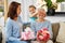 Mother and daughter greeting grandmother at home