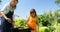 Mother and daughter grilling meat and vegetables on barbecue