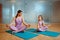 Mother and daughter in gym, yoga workout