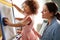 Mother And Daughter Having Fun Drawing Picture On Whiteboard At Home Together