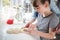 Mother And Daughter Having Fun In Kitchen At Plaiting Dough For Home Baked Bread Together