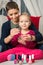 Mother and daughter having fun painting fingernails