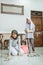 Mother and daughter in hijab clean the floor while mopping