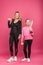 mother and daughter holding tennis rackets and ball, isolated