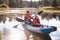 Mother and daughter kayaking on lake, front view, close-up