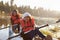 Mother and daughter kayaking on rural lake, close up