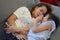 Mother and daughter laying on sofa and talking together. Happy loving family.  child girl  playing and hugging Mom on bed in