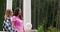 Mother and daughter looking at trees growing in tranquil park