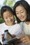 Mother and Daughter Looking at Video Camera Screen