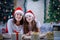 Mother and daughter lying in Christmas hats