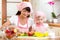 Mother and daughter making apple pie together