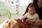 Mother And Daughter Making Autumn Decoration At Home