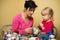 Mother and daughter making Christmas decorations