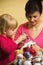 Mother and daughter making Christmas decorations