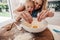 Mother and daughter making dough in kitchen