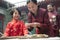 Mother and daughter making dumplings in traditional clothing