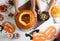 Mother and daughter making pumpkin jack o`lantern at white wooden table, top view. Halloween celebration