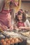 Mother and daughter making rolls