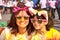 Mother and daughter in matching pink sunglasses and animal ears after a color run
