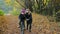 Mother and daughter in medical masks. Mom helps a girl learn to ride a bike. walking during the covid-19 coronavirus pandemic