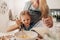 Mother and daughter mixing batter in bowl