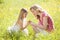 Mother and daughter outdoors holding flower