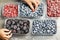 Mother and daughter picking frozen blueberries and blackberries