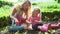 Mother And Daughter Picking Radish On Allotment