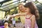 Mother And Daughter Planting Hanging Basket In Greenhouse