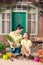 Mother and daughter with plants and flowerpots standing