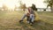 Mother and daughter play on bean bag chair in a summer park on sunset