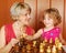 Mother and daughter play chess