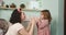 Mother and daughter play with palms. Daughter hugs and kisses mom in the bathroom.