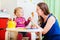 Mother and daughter playing with finger toys