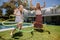 Mother and daughter playing with hula hoop in their backyard