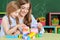 Mother and daughter playing with plastic blocks