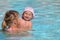 Mother with daughter in a pool