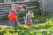 Mother and daughter pouring vegetables with plastic orange watering can