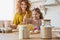 Mother and daughter prepare a cake together in the kitchen